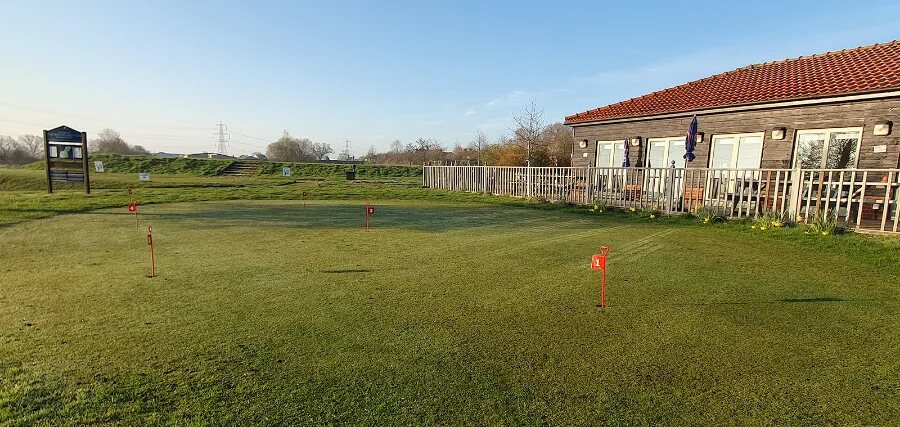 Practice putting green beside the clubhouse at The Notleys
